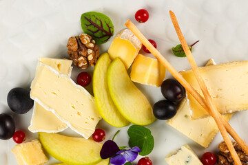 Cheese platter. Cheese appetiser dish. Close up photo with a delicious plate made with different...