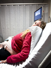 A woman in labour on her hospital bed at the delivery suite.