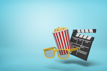 Clapperboard tipping over by popcorn tub - obrazy, fototapety, plakaty