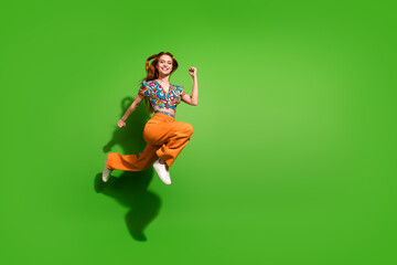 Full body portrait of pretty young girl jump run fast empty space wear top isolated on bright green color background