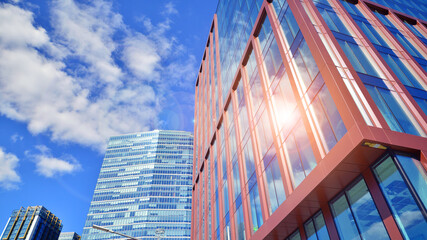 Glass building with transparent facade of the building and blue sky. Structural glass wall...
