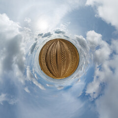 simple tiny planet without buildings in blue sky with beautiful clouds. Transformation of spherical panorama 360 degrees. Spherical abstract aerial view. Curvature of space. - 788277286
