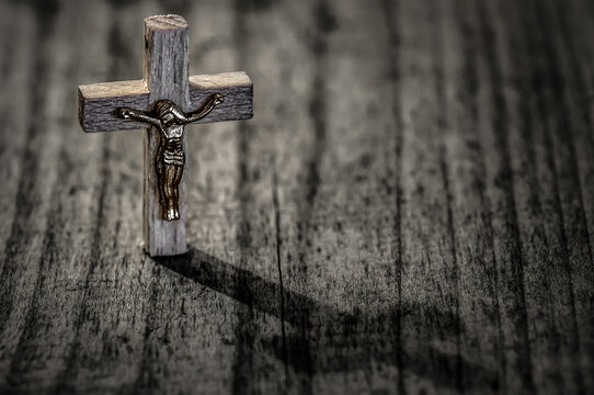 Wooden cross with crucifix and shadow