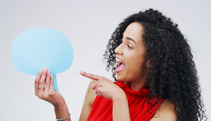Woman, pointing and happy in studio with speech bubble, gesture and idea for promotion and...