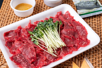 Korean food, Korean beef, beef sashimi,  beef sashimi, raw pork belly, charcoal fire, seasoning, ribs, side dishes, galbitang, rice, kimchi, ssamjang, chili peppers, garlic, radish sprouts, lettuce