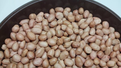 Pile of raw peanut isolated on bowl