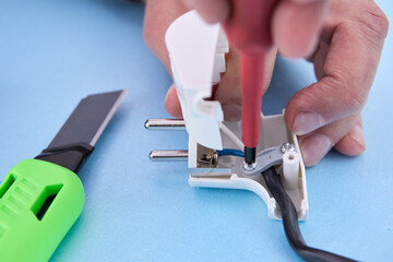 Dismountable electrical plug for an electric cord is assembled with screwdriver.
