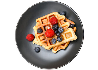 Dark grey plate with Belgian waffles and raspberries and blueberries isolated on a transparent background.