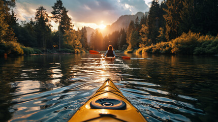 Woman kayaking on a calm lake in the mountains at sunset.