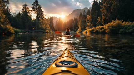 Poster Woman kayaking on a calm lake in the mountains at sunset. © D-Stock Photo
