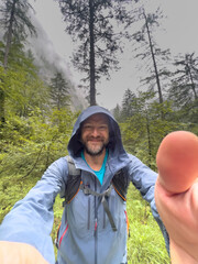 Happy Man with a selfie and the Berchtesgaden Saugasse at the background