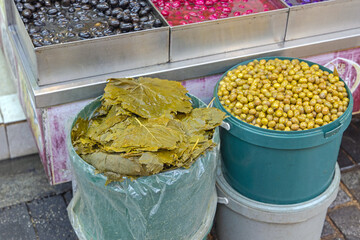 Vine Leaves and Pickled Olives in Buckets at Farmers Market