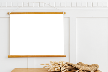 Poster hanger mockup over a wooden sideboard table with hare's tail grass in a wicker bag
