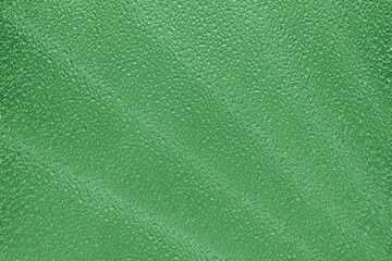 Texture of corrugated green glass. Abstract natural background.