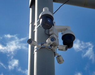 Close-up Of Security Cameras On The Street. Control and monitoring system. Metal Pole. Blue Sky. Ust-Kamenogorsk (kazakhstan)
