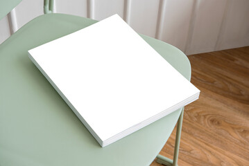 Book transparent png mockup on a pastel green chair