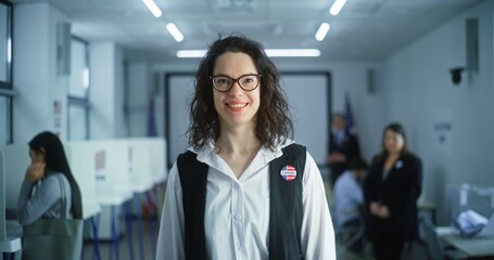 Portrait of Caucasian woman, United States of America elections voter. Woman with badge stands in...