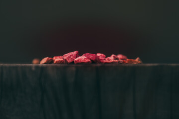 red stones lying on ebony wood,heat effect,dark background.