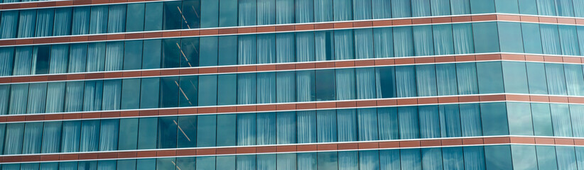 Exterior panorama view facade modern high rise hotel glass wall blackout curtains against sunny cloud blue sky in Texas, lookup view office building, skyscraper, futuristic looking architecture