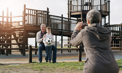 Grandparents, child and cellphone picture at park for bonding with soccer ball, playground and...