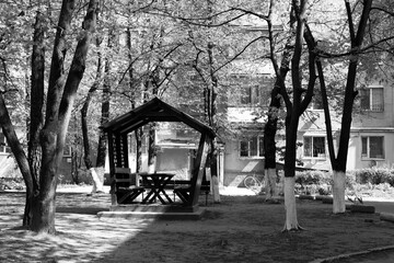 Wooden gazebo under the trees	