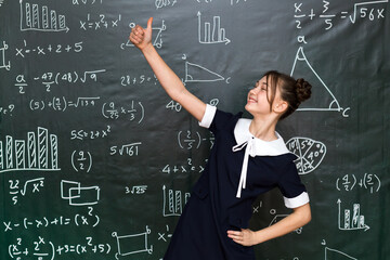 Happy teenage schoolgirl rejoices at good result in an exam, concept of success school life.