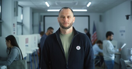 Portrait of Caucasian man, United States of America elections voter. Man with beard stands in...