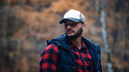 Portrait of Handsome Young Man with Cap and Checkered Shirt in Foggy Autumn Forest - 788362682