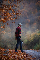 Handsome Strong Young Man in Plaid Shirt in Autumn Forest - 788363030