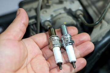 Photo of new spark plugs for change and repair with maintenance and repair concept.