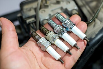 Photo of spark plug new and old spark plug,prepare for change and replace.