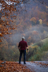 Handsome Strong Young Man in Plaid Shirt in Autumn Forest - 788363485