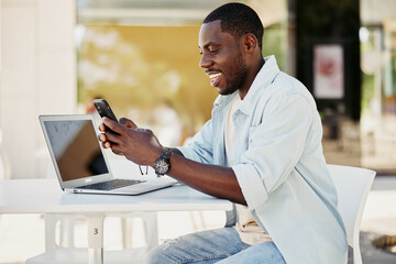 Man sitting black internet technology happy mobile male smartphone phone adult young lifestyle african