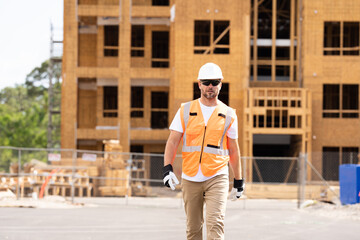 roofer builder working on roog structure of building on construction site. handsome young male...