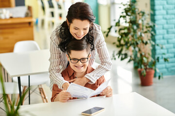 joyful good looking mother in casual clothes with her inclusive son with Down syndrome holding menu