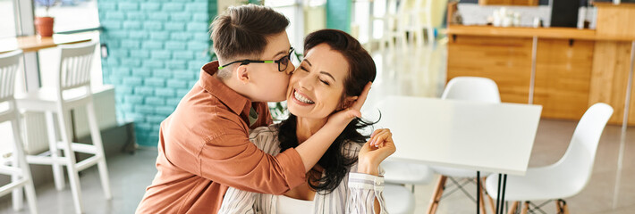 loving son with Down syndrome kissing his happy mother in cafe, horizontal banner