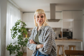 Portrait of young blonde woman at home happy positive