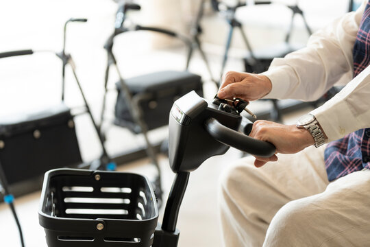 Older man in an orthopedic shop trying out an electric scooter