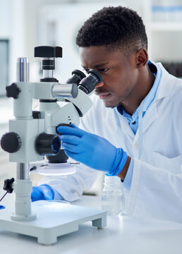 Black man, scientist and microscope in lab with analysis for test sample, experiment and dna pattern. Person, gloves and ppe for medical research at pharma company with thinking, gear and innovation