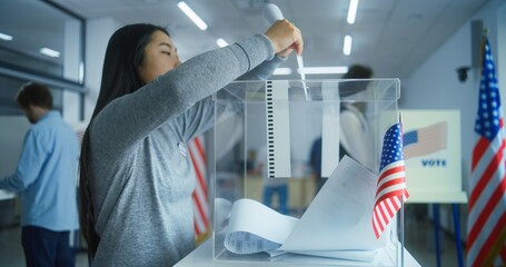 Multiethnic voters or US citizens vote in booths at polling station. Asian woman and African American female military put ballots in box. National Election Day in the United States. Democracy concept.