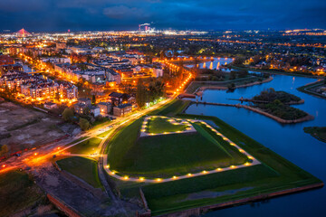 Bison bastion, 17th-century fortifications of Gdańsk illuminated at night. Poland - obrazy, fototapety, plakaty