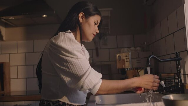 Eating strawberries, washing and preparing vegetables in the kitchen