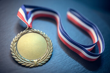 Gold medal award trophy on ribbon background - 788386042