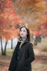 Portrait of a young Asian woman with autumn leaves