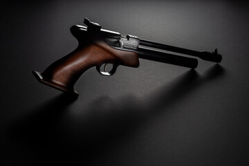 Air PCP pistol with a black gradient background and rim lights. Gun