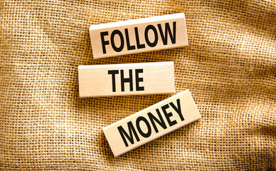 Follow the money symbol. Concept words Follow the money on beautiful wooden blocks. Beautiful...
