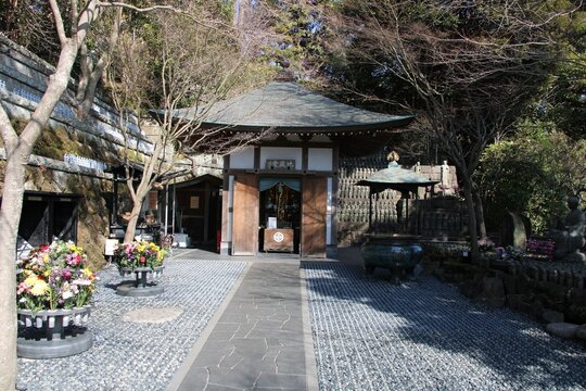Upper level of the Hase-kannon temple complex side temple  with Japanese Koro or insent burner and jizo statues in Kamakura, Japan in March
