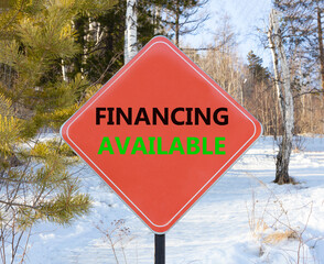 Financing available symbol. Concept words Financing available on beautiful red road sign. Beautiful forest snow blue sky background. Business financing available concept. Copy space.