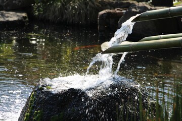 Hase-kannon temple complex Japanese garden  water leaving bamboo pipes into the lake in Kamakura,...
