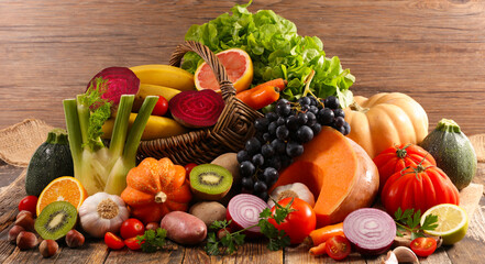 assorted fruits and vegetables on wooden background